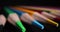 Sharpened multi-colored pencil tips on black background