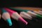 Sharpened multi-colored pencil tips on dark background