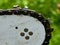 Sharpened sharp teeth of an electric saw chain on a blurred green background