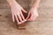 Sharpening the knife with a whetstone on a wooden background. Top view.