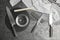 Sharpening stones, knives and water on grey table, flat lay