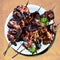 Shashlik with parsley on white plate and wood