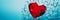 A shattered red heart against a stark blue background symbolizing heartbreak, broken relationship and emotional pain