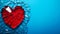 A shattered red heart against a stark blue background symbolizing heartbreak, broken relationship and emotional pain