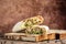 Shaurma, Kebab, pita, gyros wrap sandwich stuffed with sausages from chicken meat fresh vegetables and sauce on rustic wooden