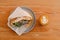 Shaverma sandwich chicken roll in pita with fresh vegetables and flat-white on wooden table top view