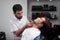 Shaves a customer\'s neck in Barbershop