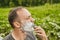 Shaving face in forest on holiday