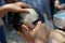 Shaving head to ordain as Thai monk