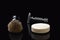 Shaving still life. A razor shaving brush and bar of soap on black