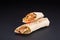 Shawarma sandwich - fresh roll of thin lavash or pita bread filled with grilled meat, mushrooms, cheese, cabbage, carrots, sauce,