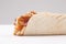 Shawarma wrap with onion and sauce on white background