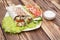 Shawarmas on lettuce isolated a wooden background