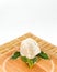 Shea butter lying on the wooden board, stands on the straw mat,