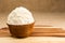 Shea butter in the wooden bowl stands on the wooden board, on th