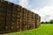 Sheaves of hay stacked into wall on the field in england uk on a sunny day