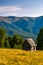 Shed on a grassy slope in mountains