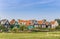 Sheep in front of colorful houses in Marken