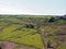 sheep grazing in fields and old farm houses surrounded by stone walls in the lumb valley in calderdale west yorkshire