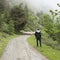 Sheep and shepherd on unpaved road in the mountains of national park des ecrins in the french alps of haute provence