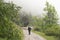 Sheep and shepherd on unpaved road in the mountains of national park des ecrins in the french alps of haute provence