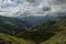 Sheeps crossing the serpentine road. Panorama of mountain valle