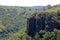 SHEER CLIFF HEAD WITH VEGETATION COVERED SURROUNDING SLOPES