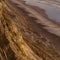 Sheer cliff secluding the shore of Blacks Beach