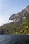 Sheer cliffs overgrown with greenery along the banks of the fjord. FiordLand National Park. South Island, New Zealand