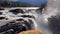 Sheer volume and force of the Athabasca River tumbling over a wide ledge