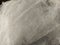 Sheer white net-like tulle. Mesh fabric wrinkled or folded carelessly. Close-up