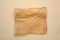 Sheet of crumpled baking paper on beige background, top view