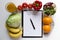 Sheet of Diet Plan and fresh products on wooden table