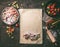 Sheet of dough with diced rhubarb and strawberries ingredients for strudel pie, on rustic kitchen table, top view. Seasonal baking