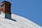 Sheet grey metal roof with two chimneys on a house