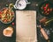 Sheet of pastry dough on rustic kitchen table with rhubarb and strawberries ingredients for strudel pie, top view. Seasonal baking