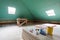 Sheets of drywall, parts of scaffolding, handle tools and construction material in the room of apartment during on the remodeling