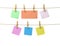 Sheets of paper of different colors on clothespins attached to a