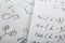 Sheets of paper with different mathematical formulas, closeup