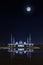 Sheikh Zayed Grand Mosque illuminated at full moon night