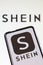 Shein logo online marketplace ecommerce on a mobile phone and computer screen