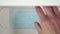 Shelf of a bedside table opens and a man takes a medical surgical mask for daily health care in a coronavirus quarantine.