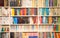 Shelf with books various colors in living room or library blurred bokeh background retro design