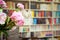 Shelf with books various colors in living room or library blurred bokeh background retro design