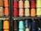 Shelf full of skeins of colored threads of wool and cotton for s