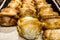 Shelf with pastries in the shop, buns, food background.