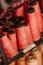 a shelf with red spools on a shelf next to a pink and black