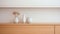 A shelf with three vases on it, AI