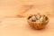 Shell almonds in wooden bowl on wooden table