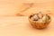 Shell almonds in wooden bowl on wooden table